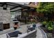 An outdoor living space showcasing a brick fireplace, patio, and comfortable seating area at 324 N 5Th St, Albemarle, NC 28001