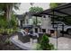 Inviting outdoor patio area with a built-in grill, fireplace, seating, and covered parking at 324 N 5Th St, Albemarle, NC 28001