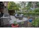 Cozy brick patio with outdoor seating, manicured landscaping, and privacy fencing at 324 N 5Th St, Albemarle, NC 28001
