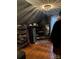 Walk-in closet with organized shelving, clothing racks, and unique attic ceiling at 324 N 5Th St, Albemarle, NC 28001