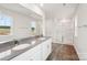 Bathroom featuring a dual sink vanity and glass-enclosed shower at 4016 Cramer Estates Ct, Gastonia, NC 28056