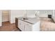 Open kitchen with central island, stainless steel dishwasher, and wood-look flooring at 4016 Cramer Estates Ct, Gastonia, NC 28056