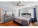 Comfortable bedroom featuring a ceiling fan, dresser and ample natural light at 42 Linford St, Belmont, NC 28012