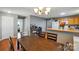 Dining room with dark wood table, hardwood floors, and view into kitchen at 42 Linford St, Belmont, NC 28012