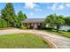 Charming single-story home with a circular driveway and well-maintained landscaping at 42 Linford St, Belmont, NC 28012