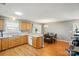 Open concept kitchen with wood cabinets, dining area, and hardwood floors at 42 Linford St, Belmont, NC 28012