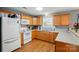 Spacious kitchen with wood cabinets, white appliances, and natural light at 42 Linford St, Belmont, NC 28012