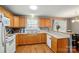 Open kitchen with wooden cabinets, breakfast bar, and stainless steel appliances at 42 Linford St, Belmont, NC 28012