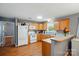 Bright kitchen with wood cabinets, white appliances, and breakfast bar at 42 Linford St, Belmont, NC 28012
