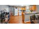 Kitchen with wood cabinets, white appliances, and wood-look flooring at 42 Linford St, Belmont, NC 28012