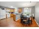 Kitchen open to dining area with hardwood floors and a large window at 42 Linford St, Belmont, NC 28012