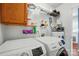 Functional laundry room featuring washer, dryer, shelves, and a water heater at 42 Linford St, Belmont, NC 28012