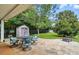 Paver patio features outdoor seating, storage shed, black fence, and mature trees at 42 Linford St, Belmont, NC 28012