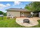 Paver patio with a fire pit, seating, black fence, AC unit, and access to the house at 42 Linford St, Belmont, NC 28012