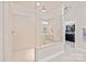Bright bathroom featuring a glass-enclosed shower with a built-in bench and a walk-in closet for ample storage at 4225 Abernathy Pl, Harrisburg, NC 28075