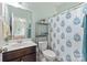 Stylish bathroom with a floral shower curtain and a vanity, offering a refreshing and clean aesthetic at 4225 Abernathy Pl, Harrisburg, NC 28075