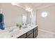 Bright bathroom featuring double vanity, large mirror, and decorative accents at 4225 Abernathy Pl, Harrisburg, NC 28075