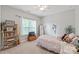Charming bedroom with a cozy bed, a large window, and ample shelving for storage and decor at 4225 Abernathy Pl, Harrisburg, NC 28075