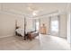 Spacious bedroom with neutral carpet, a four-poster bed, and lots of natural light at 4225 Abernathy Pl, Harrisburg, NC 28075