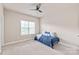 Neutral bedroom featuring a bed with a blue comforter, complemented by a bright window at 4225 Abernathy Pl, Harrisburg, NC 28075