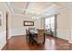 Elegant dining room featuring coffered ceilings, hardwood floors, and stylish décor at 4225 Abernathy Pl, Harrisburg, NC 28075