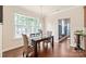Cozy dining area with natural light, wooden table, wicker chairs, and backyard view at 4225 Abernathy Pl, Harrisburg, NC 28075