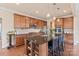 Modern kitchen with wood cabinets, granite countertops, stainless steel appliances, and a central island at 4225 Abernathy Pl, Harrisburg, NC 28075