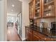 Well-lit kitchen with stainless steel appliances, wooden cabinets, granite countertops, and adjacent breakfast area at 4225 Abernathy Pl, Harrisburg, NC 28075