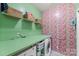 Bright laundry room with ample storage, modern appliances, and patterned wallpaper at 4225 Abernathy Pl, Harrisburg, NC 28075