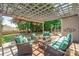 Charming outdoor patio with pergola, comfortable seating, and lush greenery at 4225 Abernathy Pl, Harrisburg, NC 28075