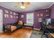 Purple bedroom with a ceiling fan, a desk and interesting wall art at 509 W Sixth Ave, Gastonia, NC 28052