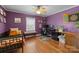 Purple bedroom with a ceiling fan, a desk, and a small bench at 509 W Sixth Ave, Gastonia, NC 28052