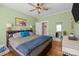 Comfortable bedroom featuring hardwood floors, a ceiling fan, and a large bed with a headboard at 509 W Sixth Ave, Gastonia, NC 28052