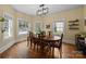 Charming dining room featuring hardwood floors, a wooden table, and natural light from large windows at 509 W Sixth Ave, Gastonia, NC 28052