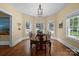 Bright dining room features hardwood floors, a bay of windows and stylish lighting at 509 W Sixth Ave, Gastonia, NC 28052