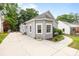 Charming gray home with a well-kept lawn, adjacent driveway, and a neighbor's home nearby at 509 W Sixth Ave, Gastonia, NC 28052