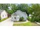 Charming gray home featuring a bay window, vinyl siding, manicured lawn and adjacent driveway at 509 W Sixth Ave, Gastonia, NC 28052