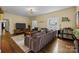 Cozy living room featuring hardwood floors, a large sectional sofa, and ample natural light at 509 W Sixth Ave, Gastonia, NC 28052