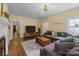 Spacious living room featuring hardwood floors, a large TV, and an extra large comfortable sofa at 509 W Sixth Ave, Gastonia, NC 28052
