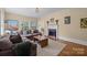 Comfortable living room with hardwood floors, a fireplace, large sectional, and scenic artwork at 509 W Sixth Ave, Gastonia, NC 28052