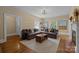 Inviting living room with hardwood floors, a large sectional sofa, and vintage decor at 509 W Sixth Ave, Gastonia, NC 28052