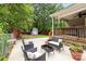 Spacious outdoor patio with comfortable seating, a shed, and lush greenery at 509 W Sixth Ave, Gastonia, NC 28052