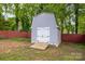 Backyard shed with double doors, ramp, and neutral siding, providing convenient outdoor storage at 509 W Sixth Ave, Gastonia, NC 28052