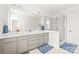 Spacious bathroom with double vanity, white countertops, gray cabinets, and glass-enclosed shower at 5210 Kelly St, Charlotte, NC 28205