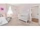 Bright Bedroom featuring soft pink walls, plush carpeting, and a cozy reading nook with a chair at 5210 Kelly St, Charlotte, NC 28205