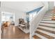Elegant dining area with stylish lighting, wood floors, adjacent to a staircase and a cozy living room at 5210 Kelly St, Charlotte, NC 28205