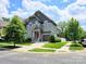 Charming two-story home with a red door, manicured lawn, and attached garage at 5210 Kelly St, Charlotte, NC 28205