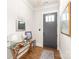 Bright foyer with hardwood floors, a decorative table and a charming mirror and artwork at 5210 Kelly St, Charlotte, NC 28205