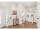 Upstairs hallway with hardwood floors, white walls, artwork, and decorative furnishings at 5210 Kelly St, Charlotte, NC 28205