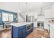 Bright kitchen featuring a blue island, stainless steel appliances, and hardwood flooring at 5210 Kelly St, Charlotte, NC 28205